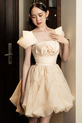Modyis Champagne Off Shoulder Mini Dress with Bow & Rose Bodice Detail